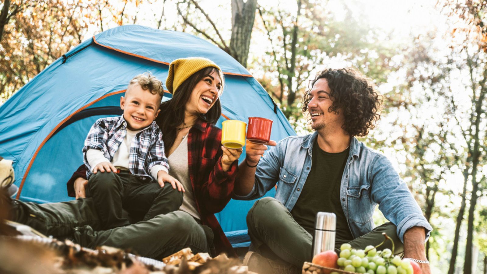 happy young family camping outside tent fall autumn