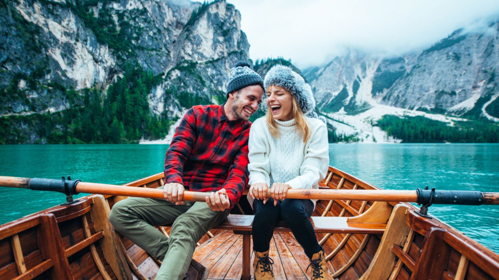 travelers winter mountains boat cold happy couple