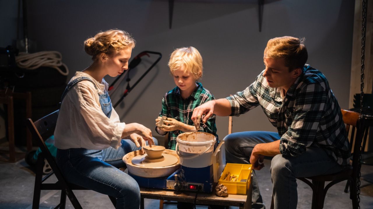 A family of mom, dad and son spend their free time behind a Potters wheel in the workshop.