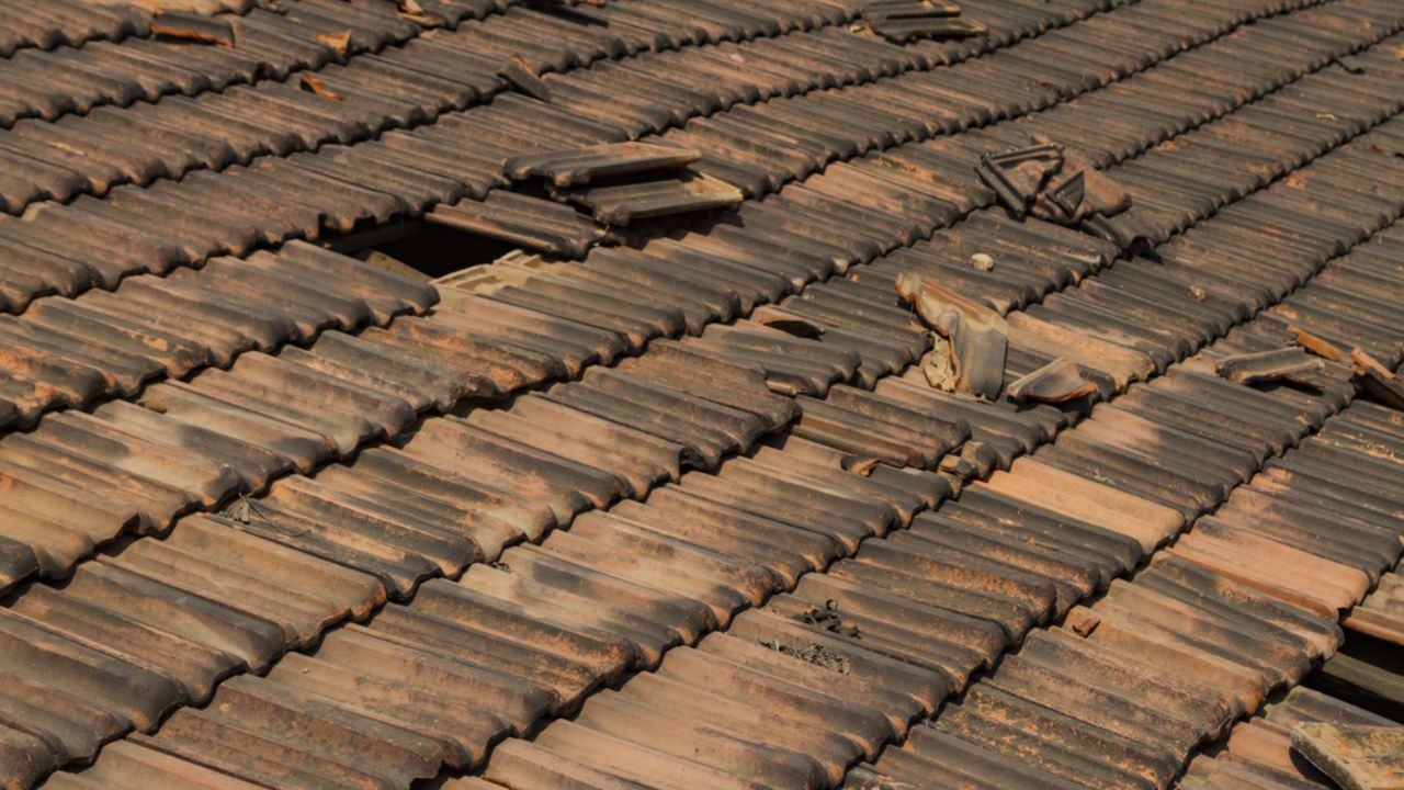 Broken old terracotta rooftiles with hole