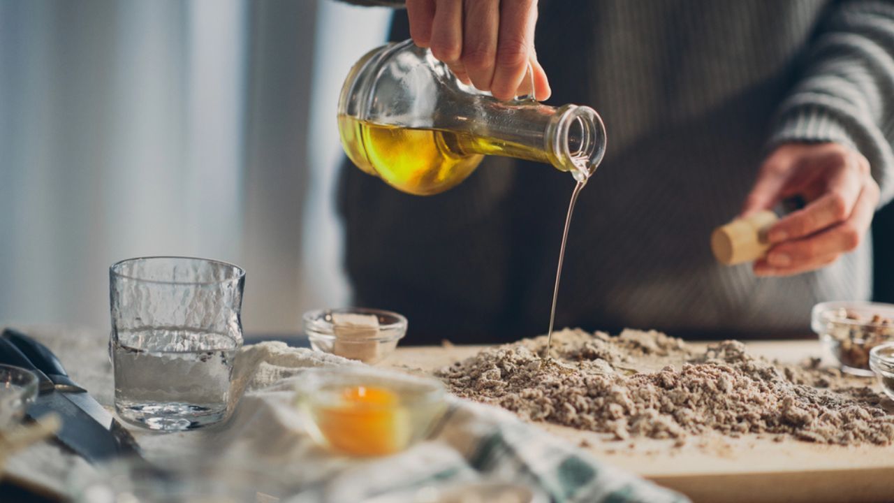 Close up of woman`s hands making a bread.