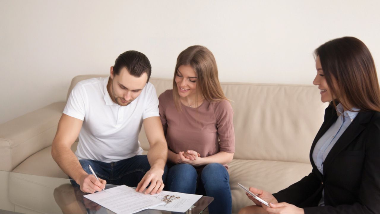 Couple signing agreement for buying renting apartment, mortgage