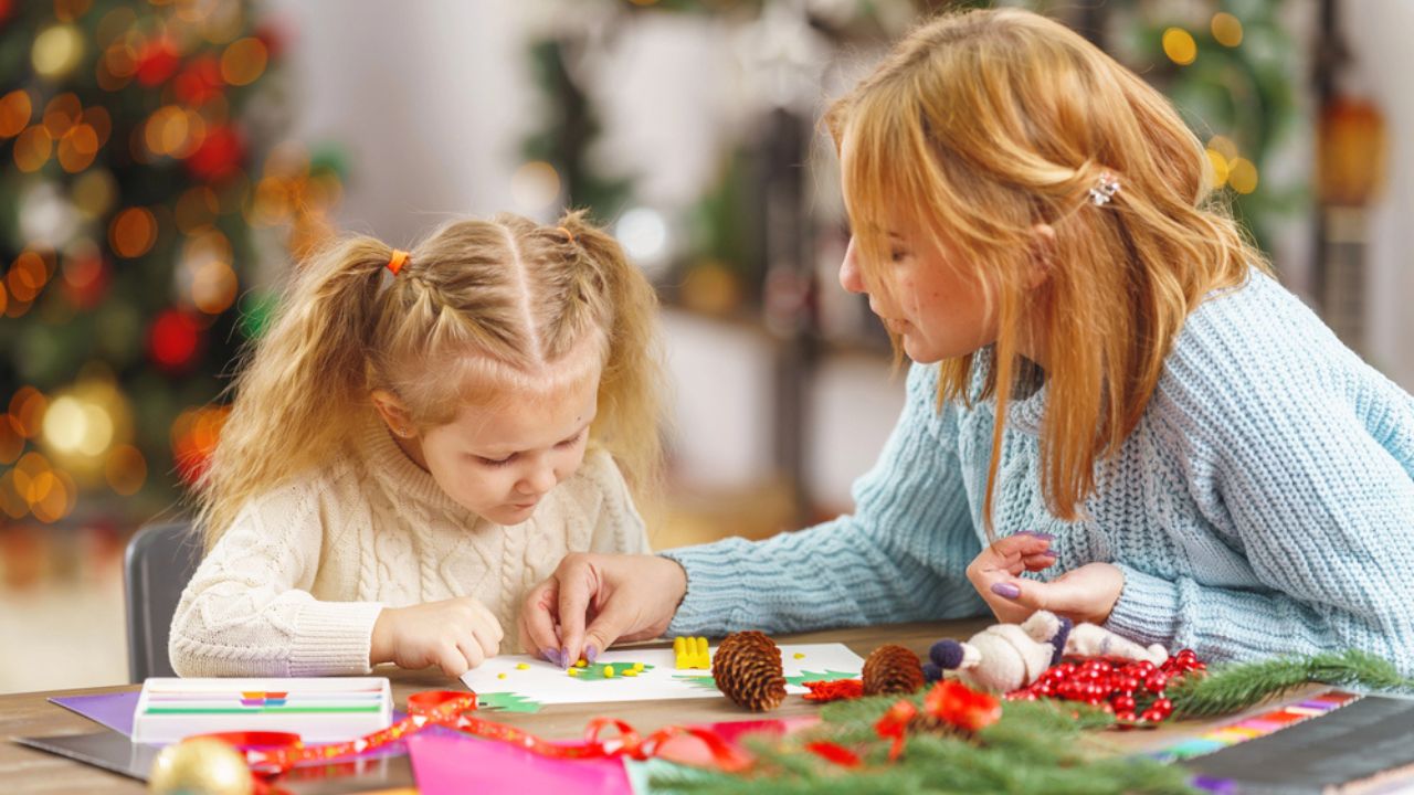 Cute little girl and her mother are engaged in needlework, creativity, enjoying the process, 