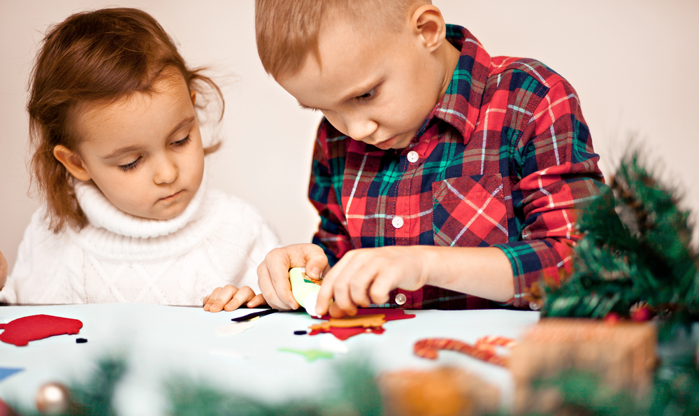 Kids making decor for Christmas tree or gifts. Christmas handmade diy project.
