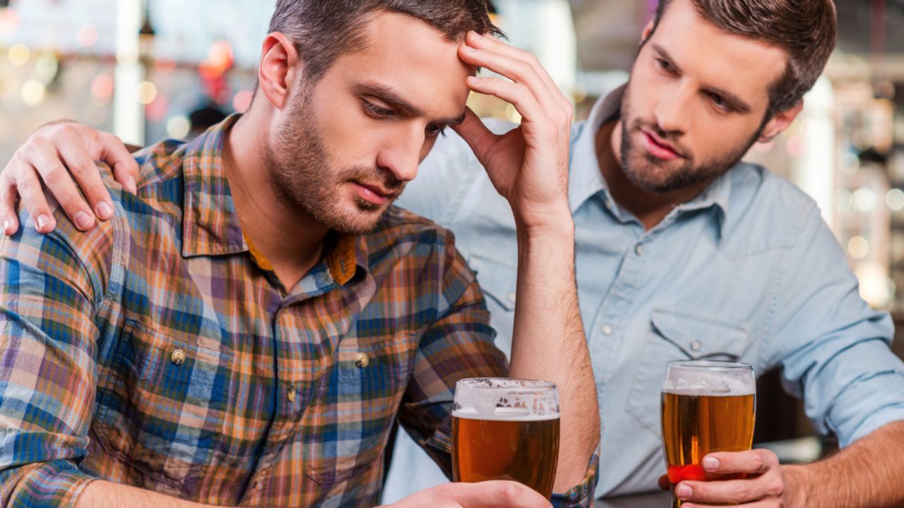 Depressed man sitting at the bar counter