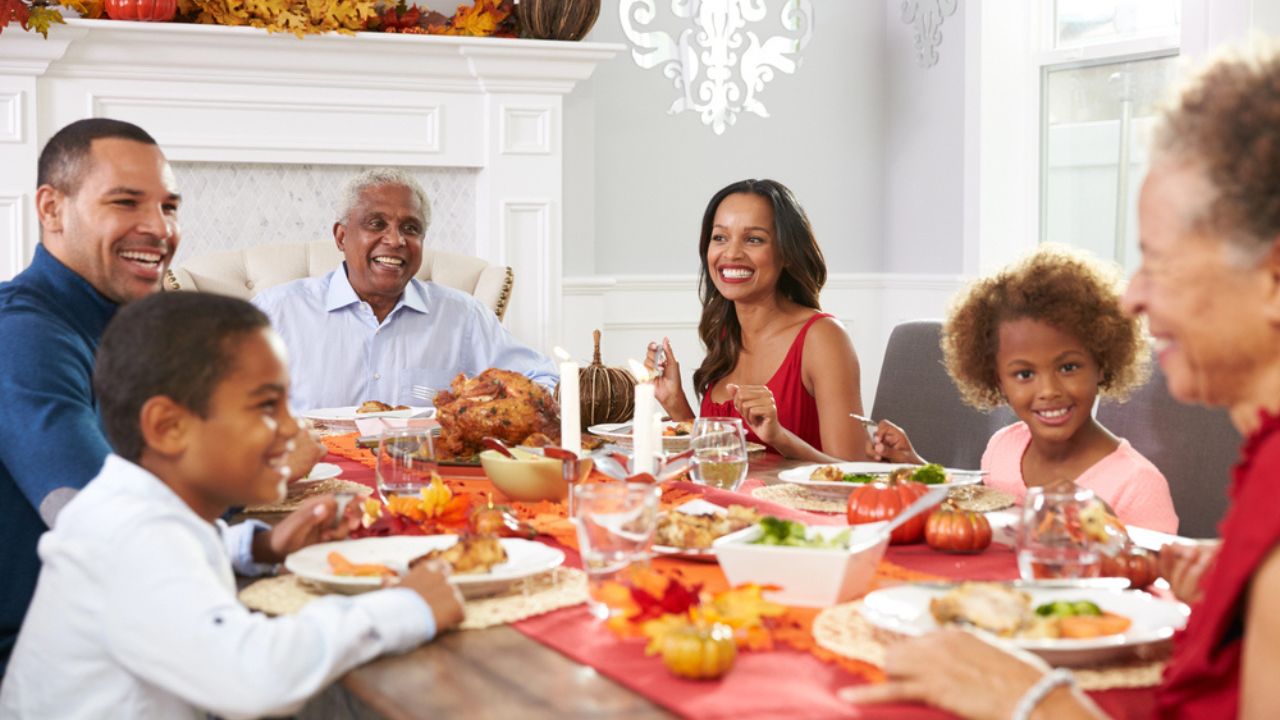Family Enjoying Thanksgiving Meal At Table