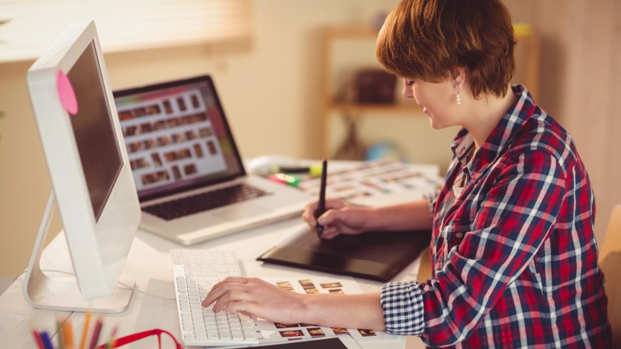 Focused photographer looking pics on her computer