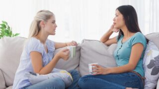 Friends drinking coffee and having a serious chat