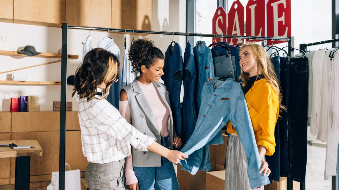 Group of multiethnic shopaholics on shopping in clothing store
