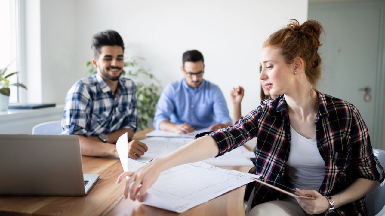 Happy creative coworkers working in designer office