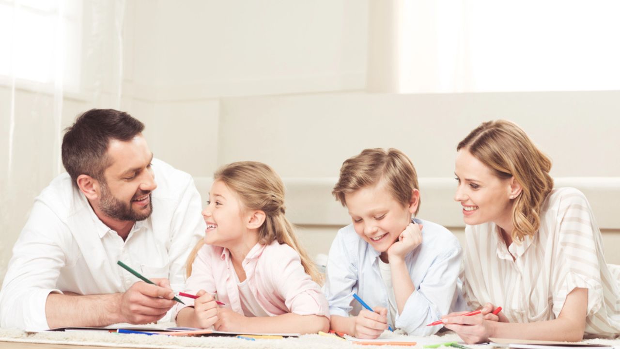 Happy family drawing pictures at home