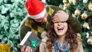 Man In Surprising Woman With Christmas Gift At Store