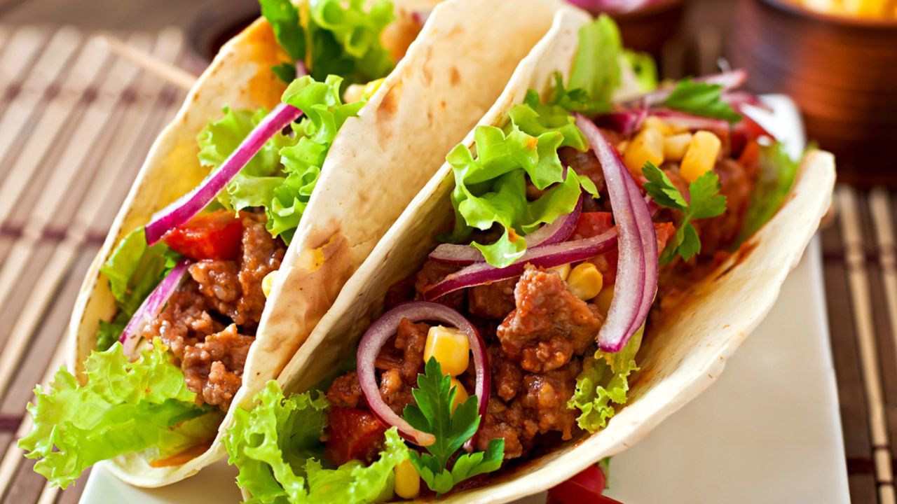 Mexican tacos with meat, vegetables and onion