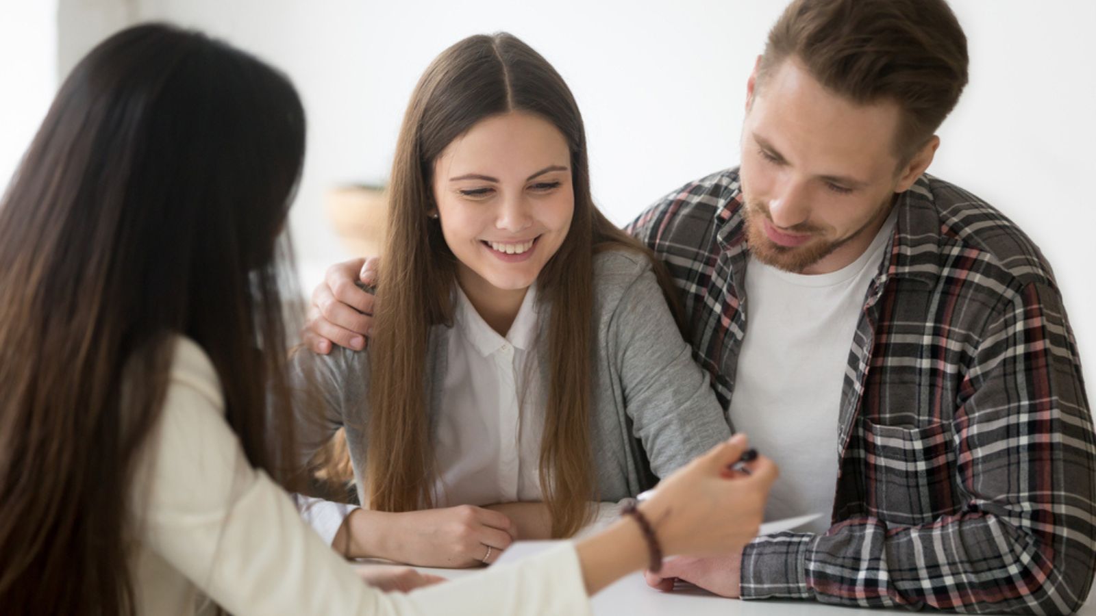 Millennial couple considering mortgage investment loan or insurance.