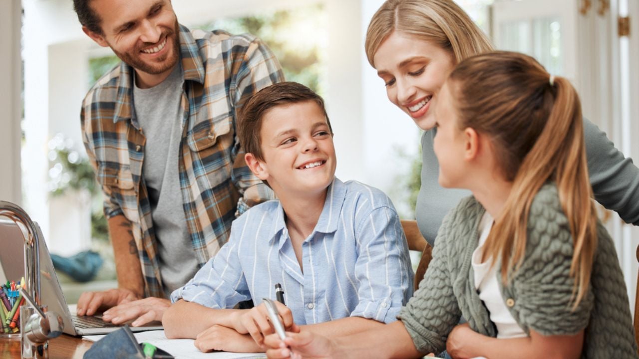 Morning learning at its finest. a young family doing homework together at home