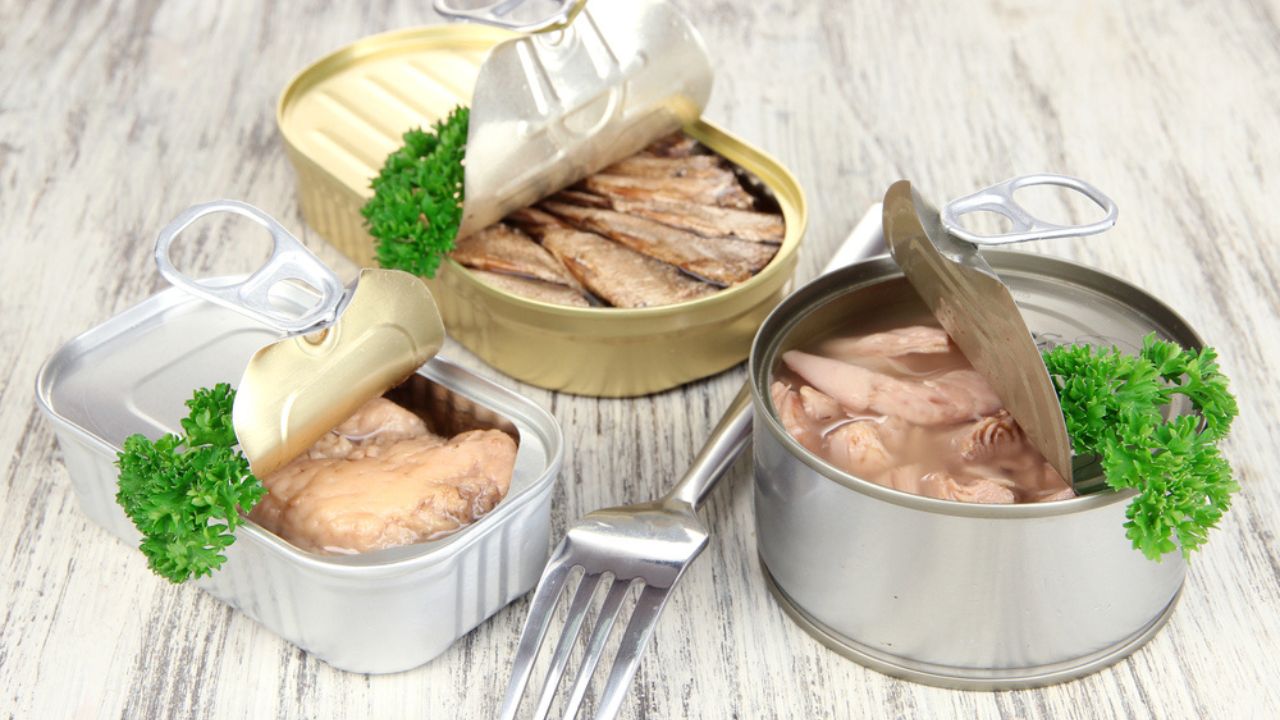 Open tin can, on wooden background