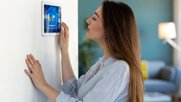 Shot of pretty young woman using the home automation system on digital tablet to regulate the temperature.