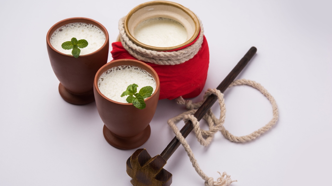 lassie or lassi in terracotta glass - Lassi is an Authentic Indian cold drink made up of curd and milk and sugar, selective focus