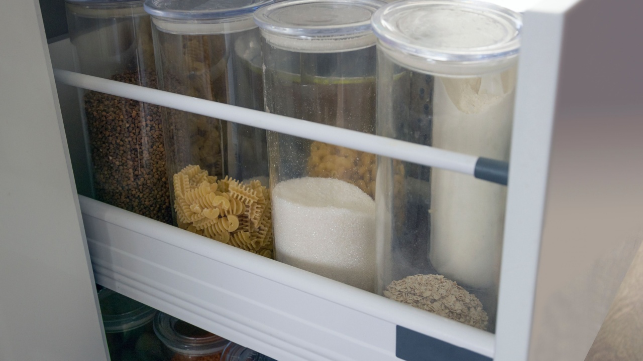 Side view of a spices and groceries organized in a modern kitchen drawer.