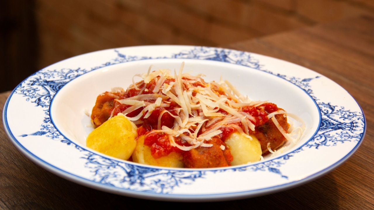 Gnocchi. Roasted Italian pasta with tomato sauce, parmesan cheese and meatballs.