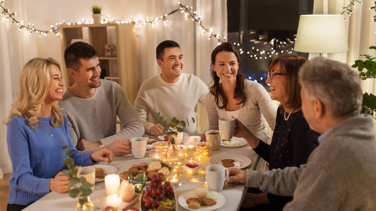 celebration, holidays and people concept - happy family having tea party at home