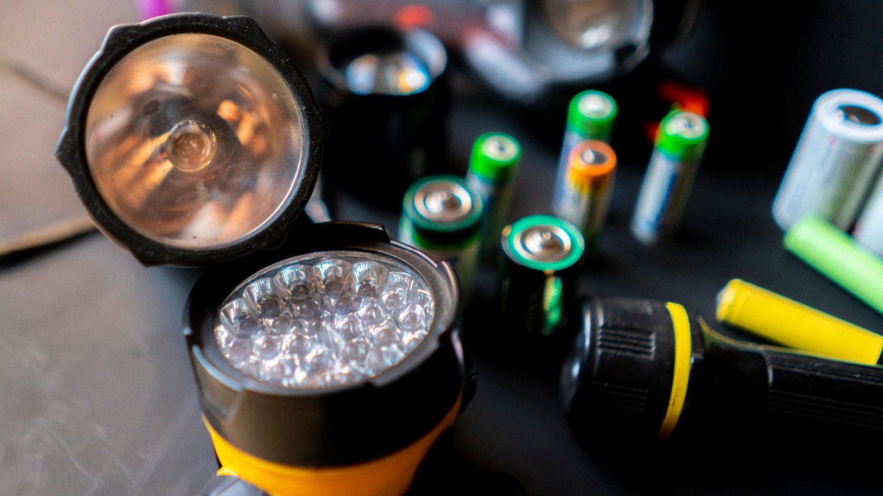 persons hands hold a flashlight in a workshop