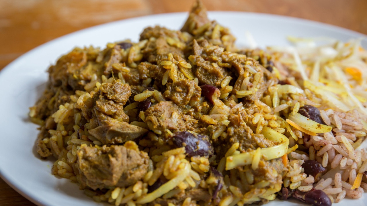 Jamaican Curried Goat served with traditional rice and peas
