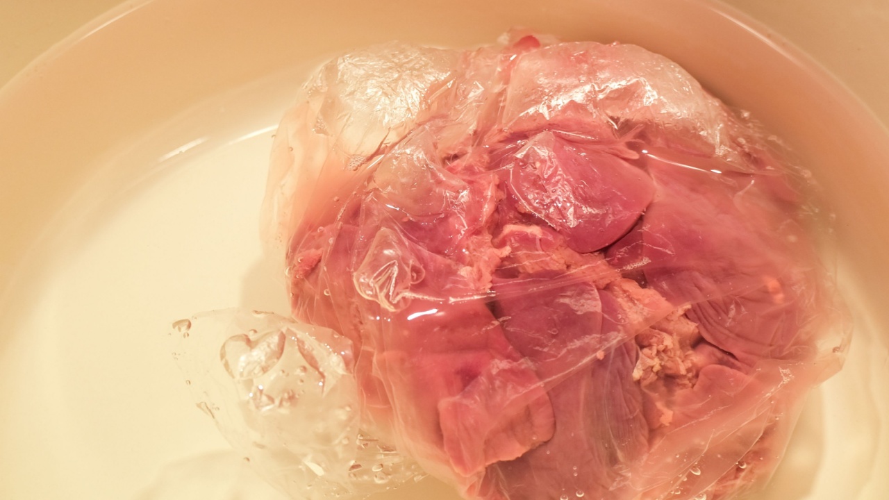 Defrosting meat in water. Frozen liver.