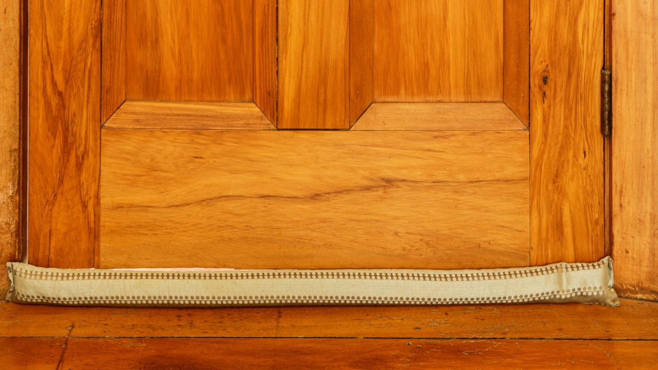 A material draught stopper used to prevent drafts in winter, on a wooden floor