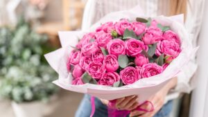 Lots of buds Roses of pink fuchsia color. Bouquet in woman hand. the work of the florist at a flower shop Flower shop