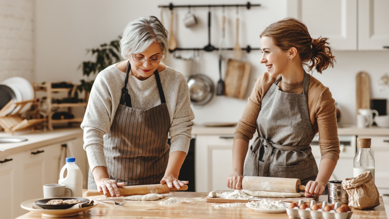 happy family grandmother old mother mother-in-law and daughter-in-law daughter cook in kitchen, knead dough and bake cookies