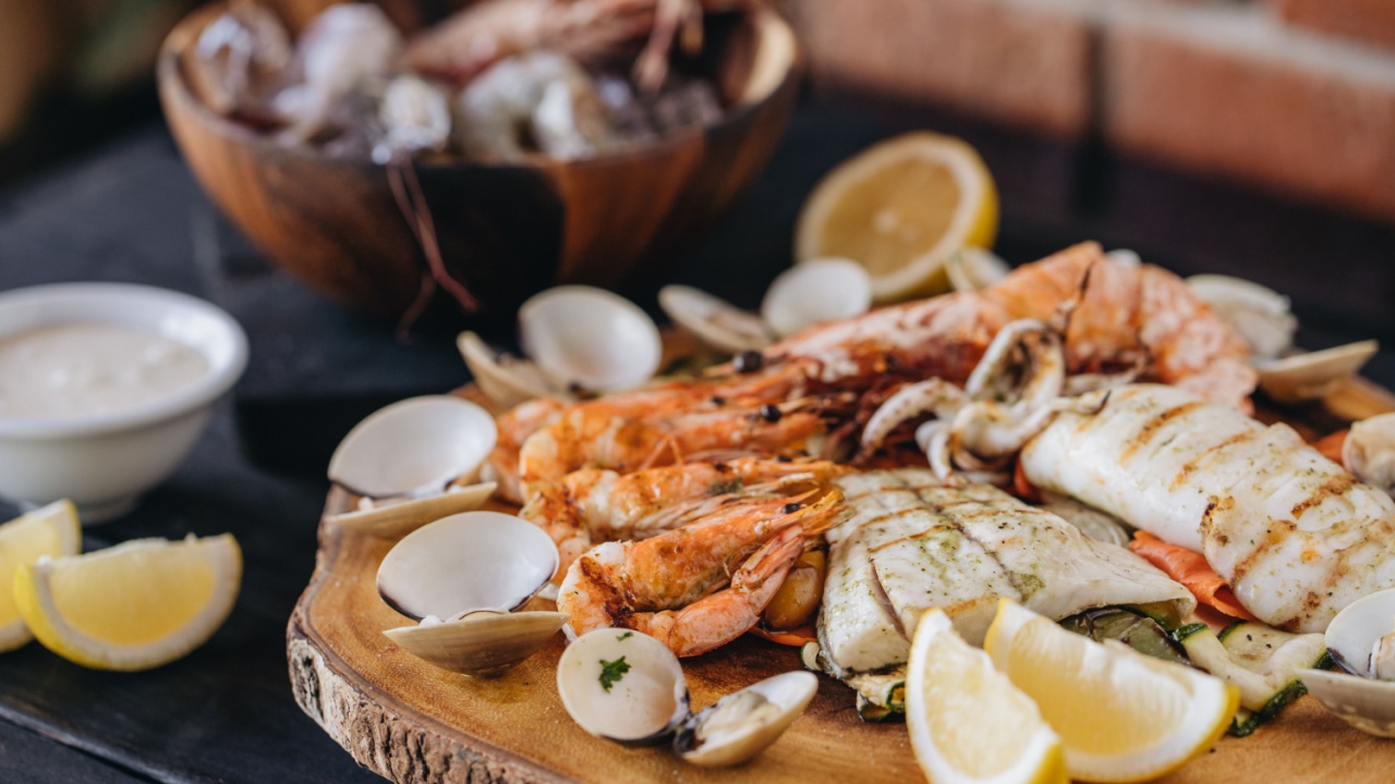 Seafood platter on a black wooden table. Top view