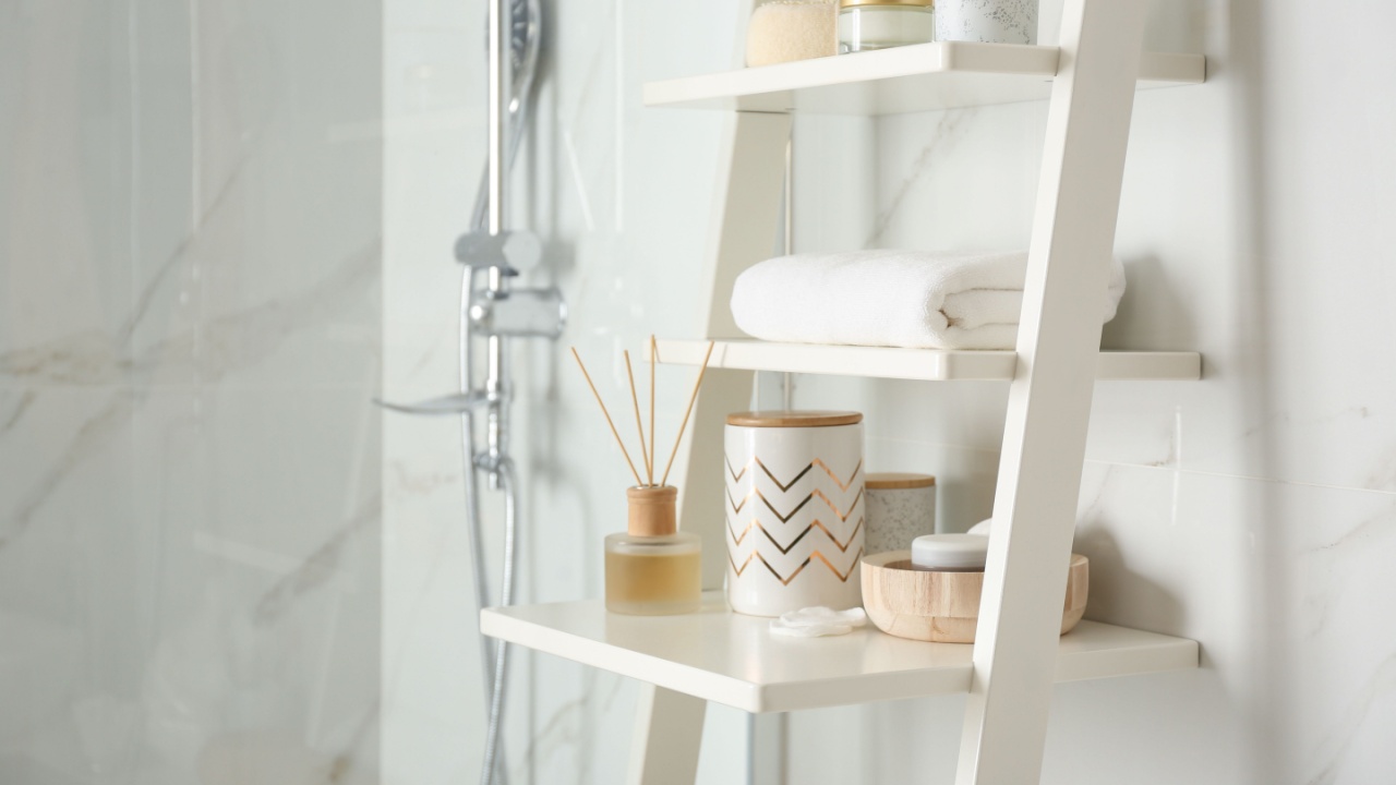 Shelving unit with different items in bathroom interior