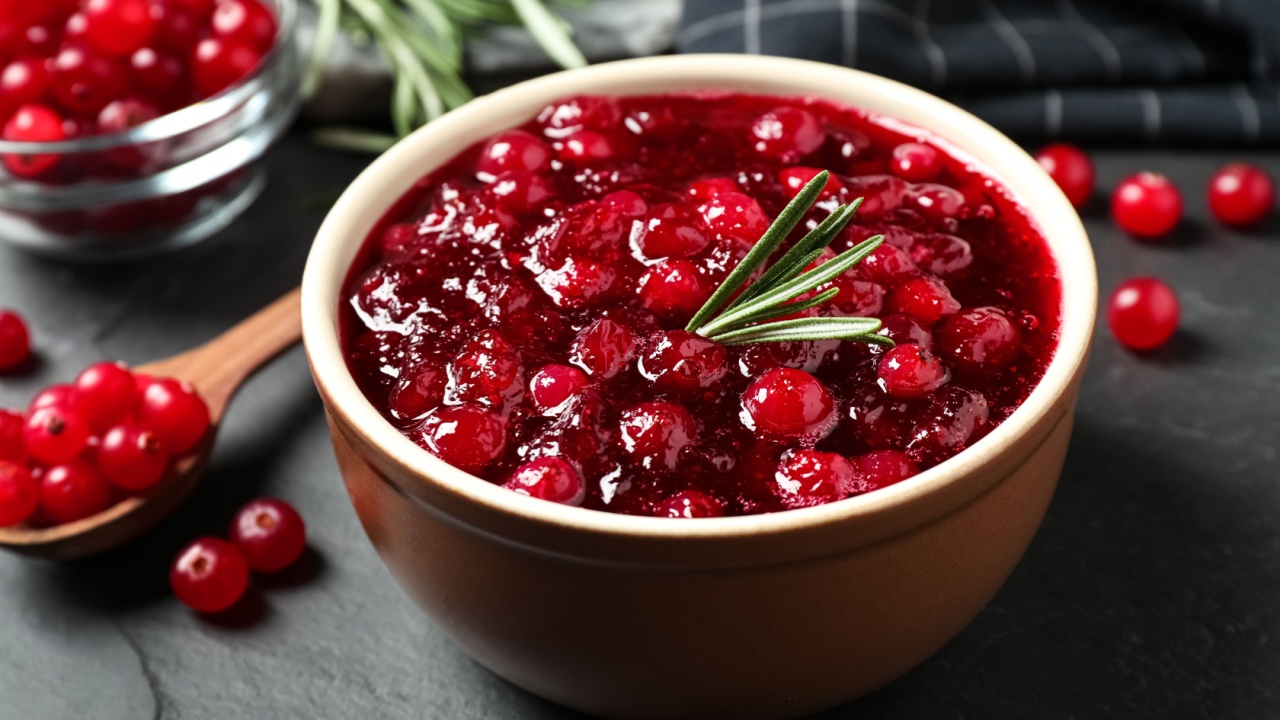 Cranberry sauce in bowl on dark grey table