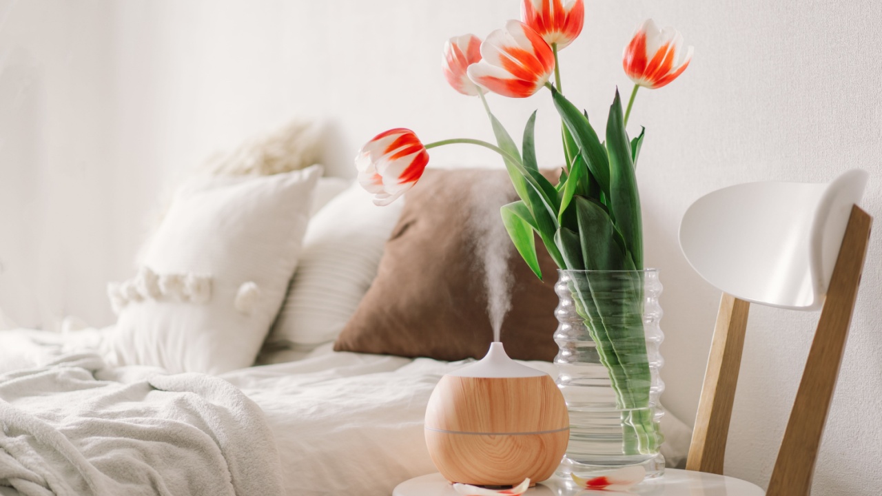 Aromatherapy Concept. Aroma oil diffuser on chair against in the bedroom. Air freshener. Ultrasonic aroma diffuser for home