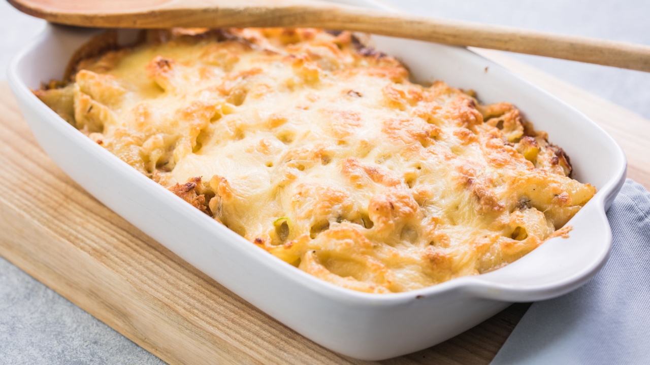 Tetrazzini -chicken pasta casserole in a baking dish with ingredients at background, american cuisine, view from above