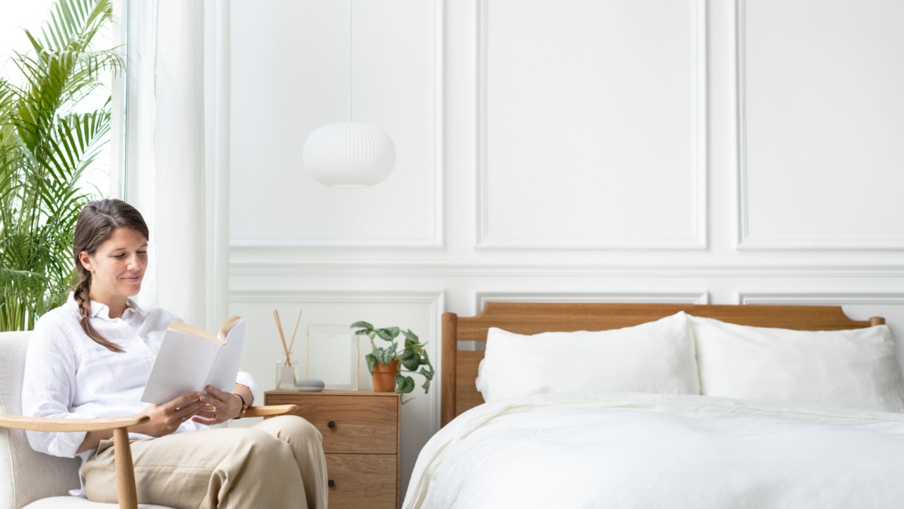 Woman reading a book in her bedroom