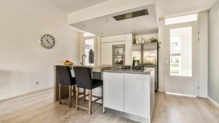 Small cozy kitchen with a breakfast bar and an exit to the outside of the house
