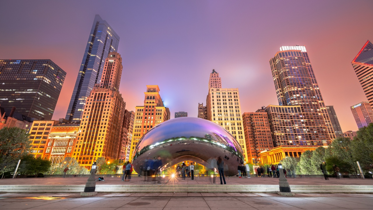 CHICAGO - ILLINOIS: MAY 12, 2018: Tourists visit Cloud Gate in Millennium Park in the evening.