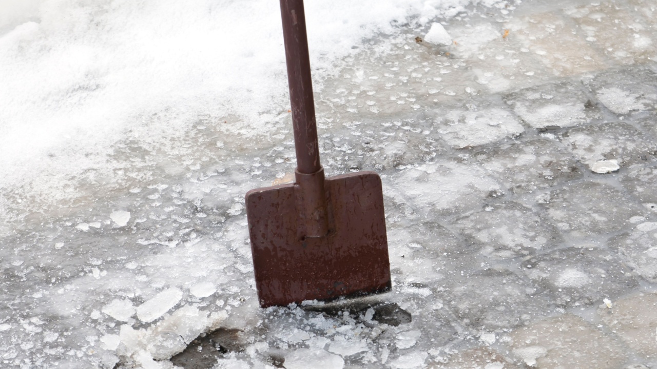 Ice breaking tool. Cleaning the road with icebreaker tool. Ice removal in spring. Vertical orientation.