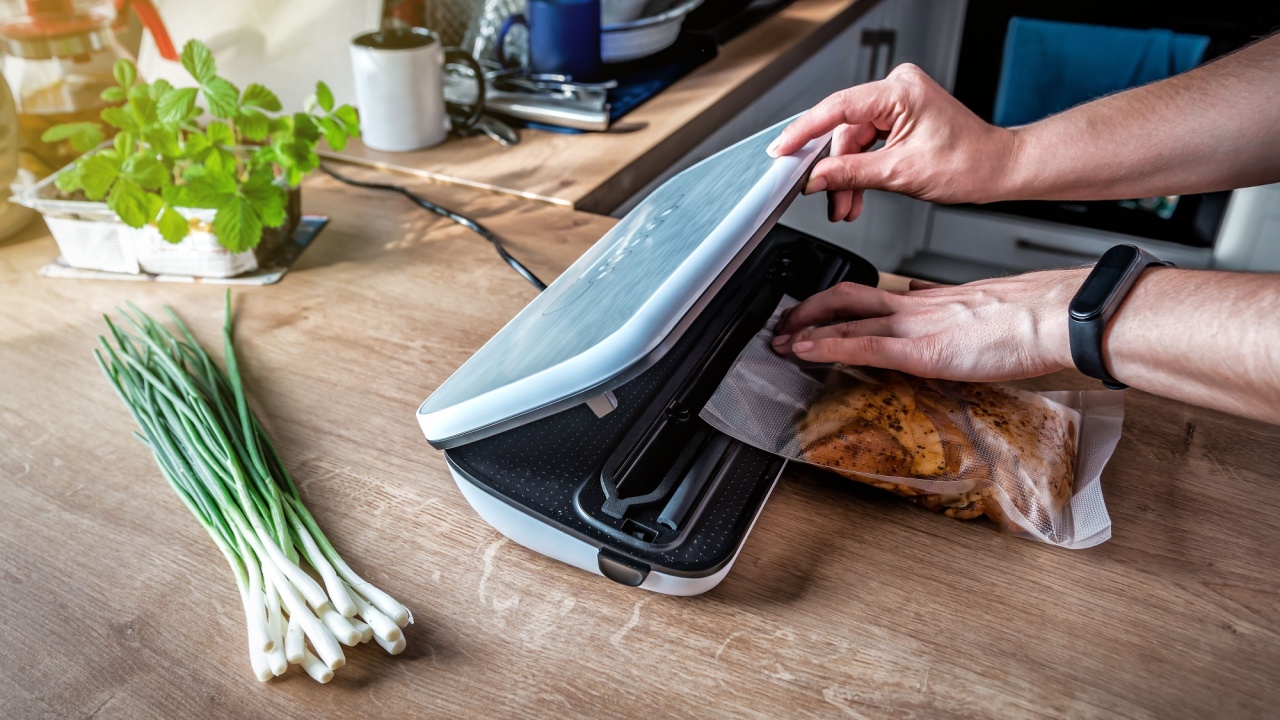 Woman using vacuum seal machine for vacuum packing meat in plastic bags. Bunch of green onion on the table