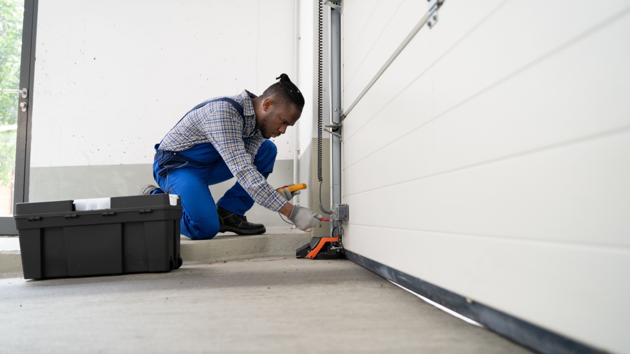 Garage Door Installation And Repair At Home. Contractor Man In House