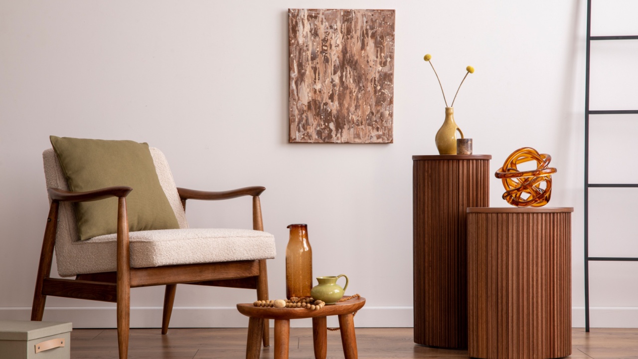 Retro and bright space of living room with mock up poster frame, wooden side table, beige armchair ,green pillow and elegant personal accessories. Beige wall. Minimalist home decor. Template.