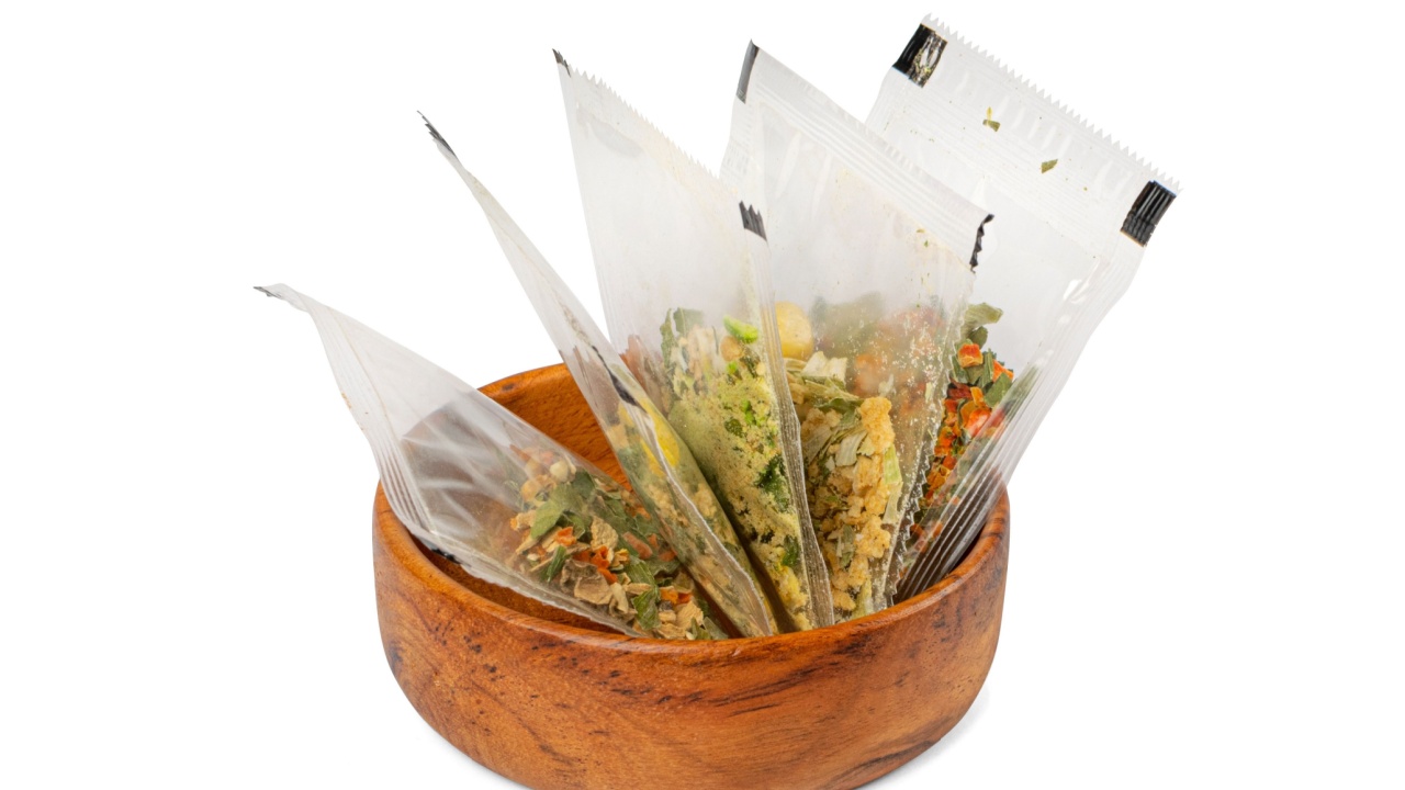 Small Spice Pouch Isolated, Dried Vegetables and Herbs Mix in Plastic Bag, Dry Peas, Greens, Dehydrated Food Pieces on White Background, Clipping Path