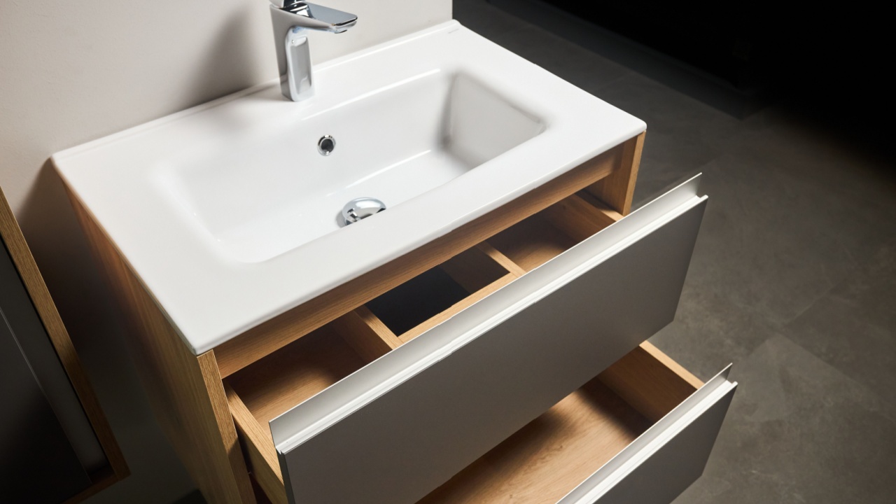 Solutions for placing things in bathroom horizontal sliding pull out drawer shelves storage in a cupboard under stoneware washbasin cabinet under sink and faucet. Modern loft flat minimalistic design.
