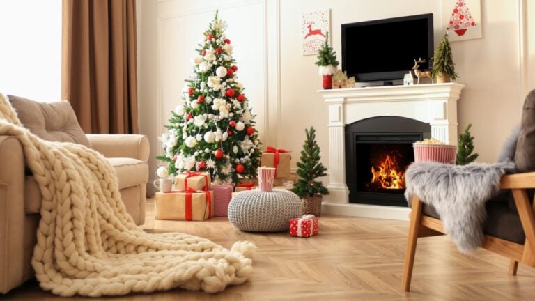 Stylish living room interior with TV set, Christmas tree and fireplace