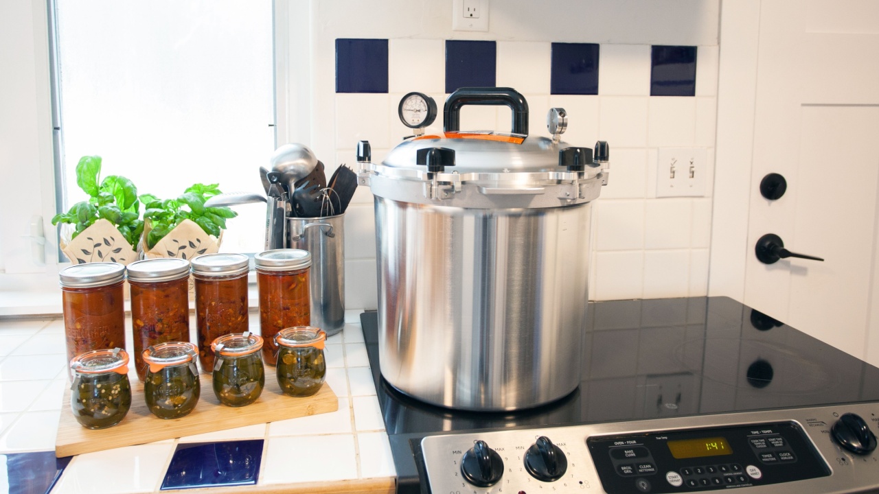 Home Canning jalapenos in jars and a batch of chili with a pressure cooker. Food preservation is key to gardening and homesteading. Pressure canning makes food shelf stable.