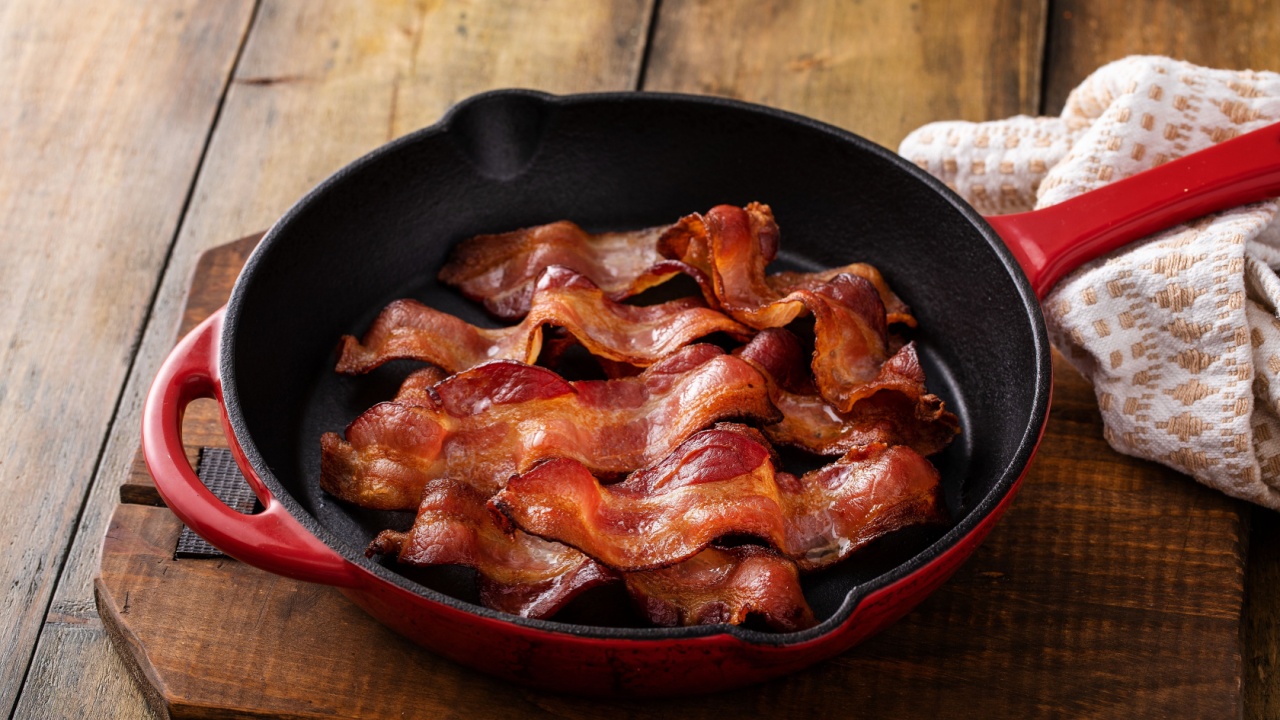 Cooked bacon in a cast iron pan, ready to eat breakfast staple