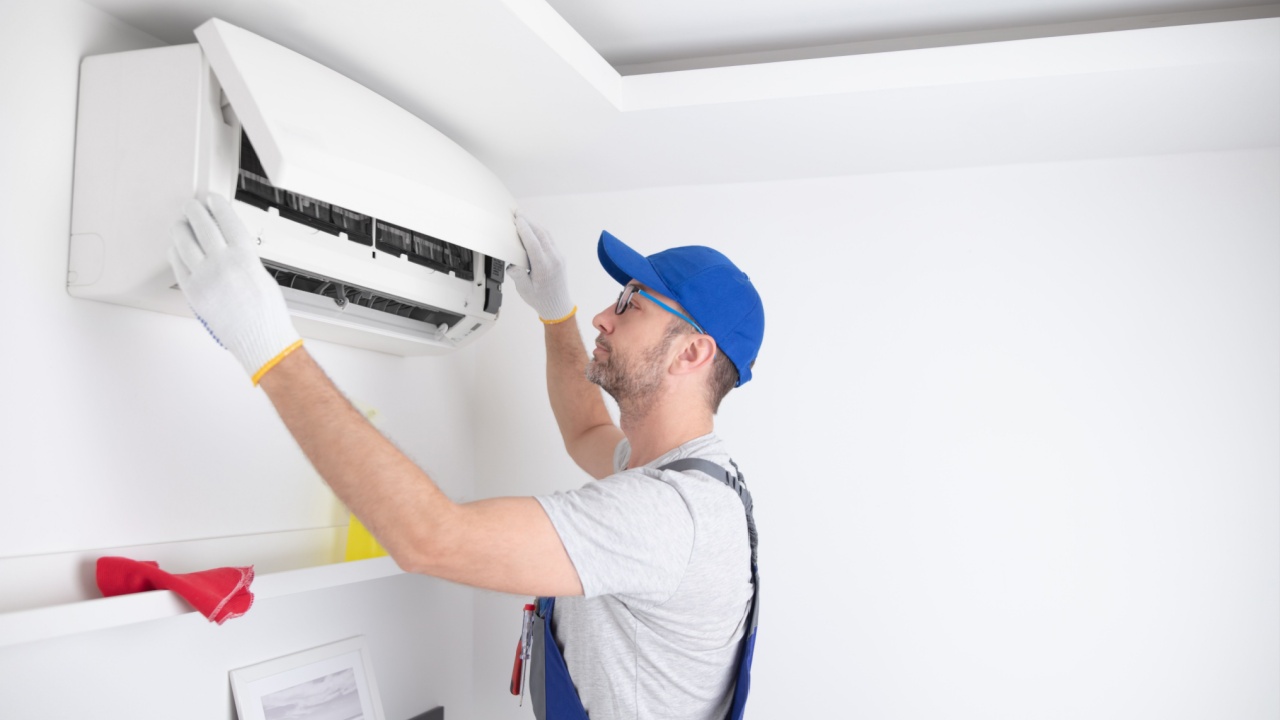 Service guy cleaning and maintaining air condition unit.