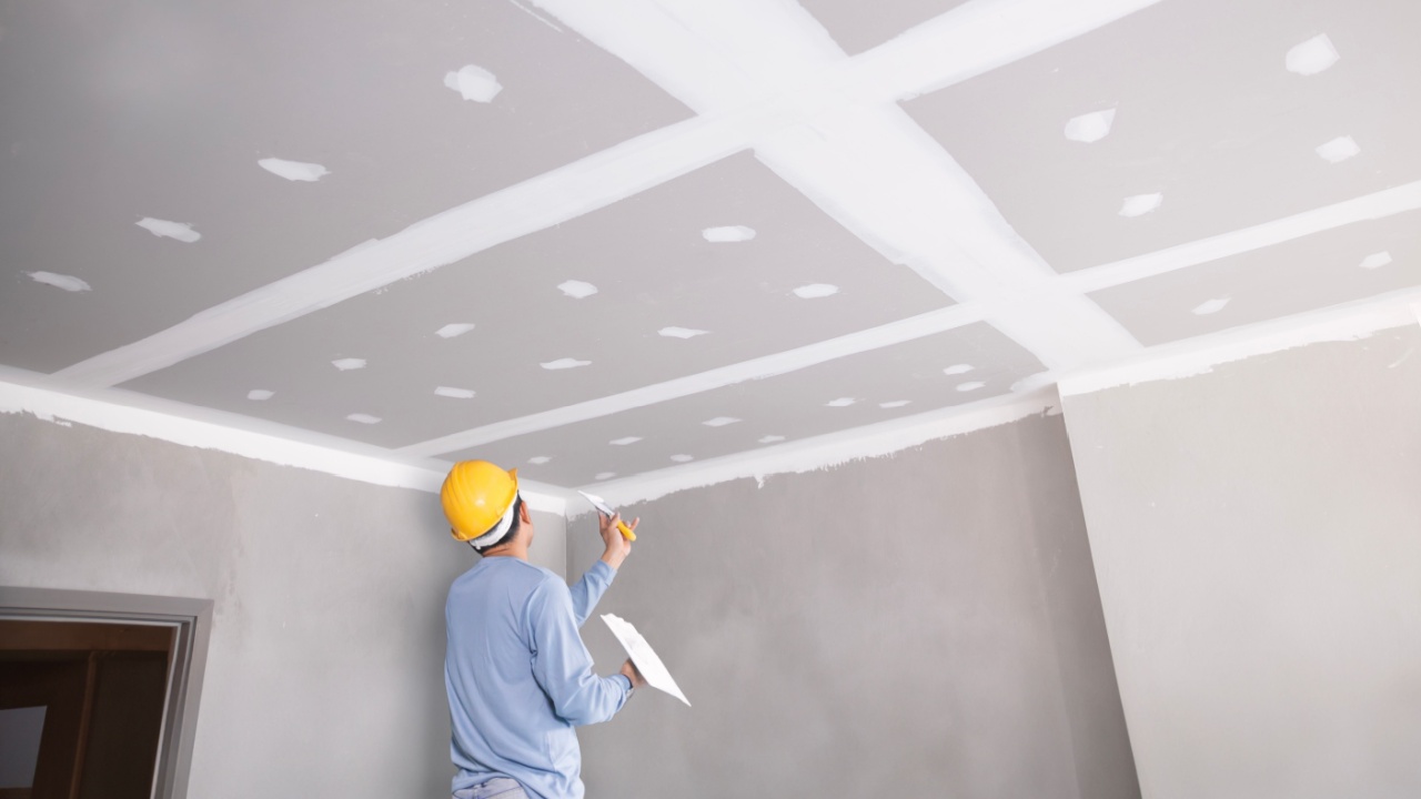Craftsman workingwith plaster gypsum ceiling for interior build gypsum board ceiling in construction sit.